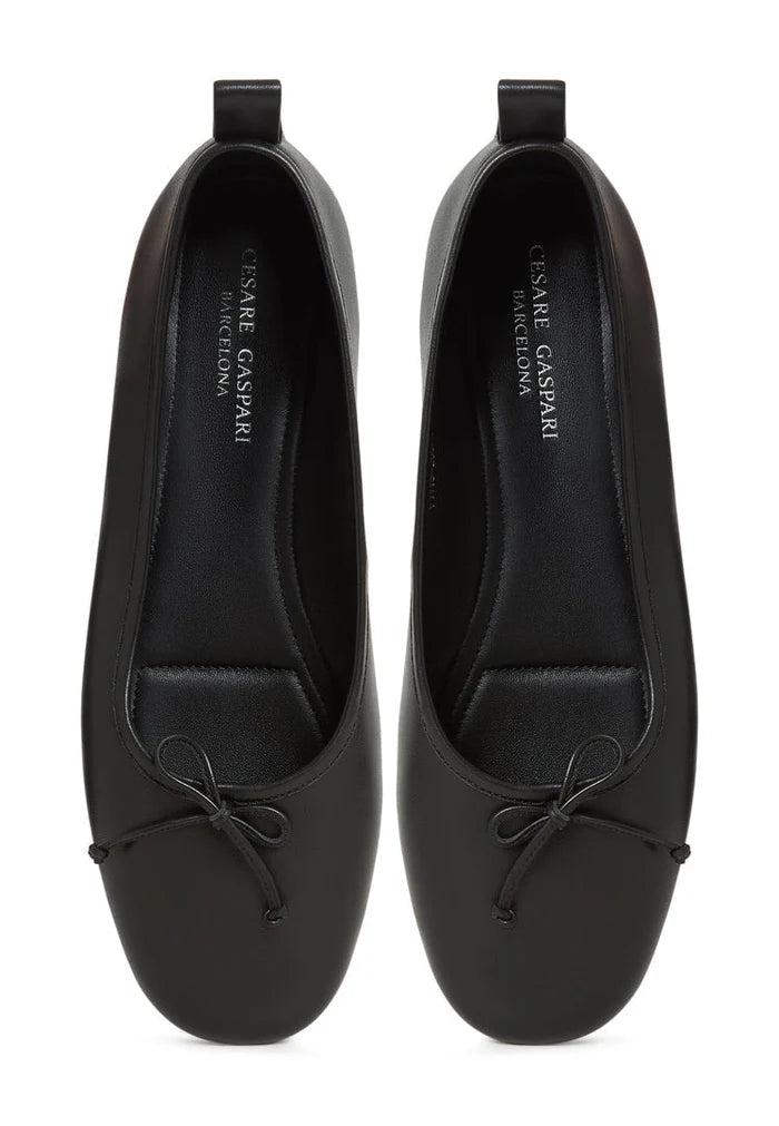 A pair of elegant black leather ballerinas, women's flats by Mila, perfect for any occasion.