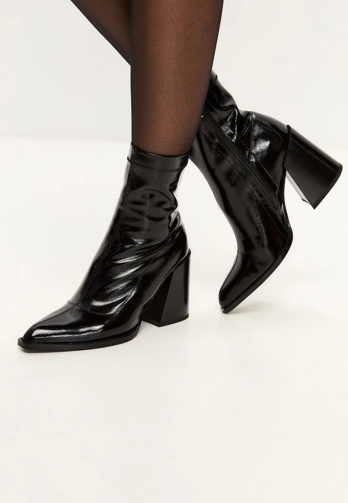A pair of stylish women's leather block heel Layla boots in shiny patent black, featuring a chunky heel design.
