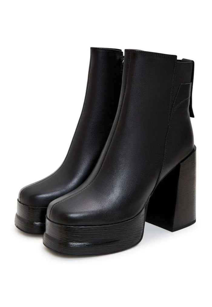 Pair of stylish leather ankle boots with block heels, perfect for completing any chic outfit.