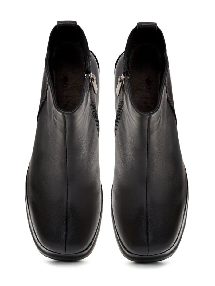 A pair of stylish leather ankle boots with block heels perfect for any fashion-forward outfit.