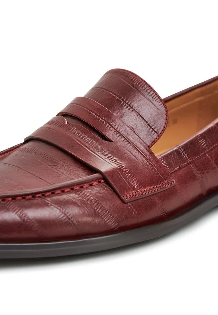 A stylish pair of women's leather loafers and block heeled shoes in Bordeaux, combining fashionable heels with classic loafers.