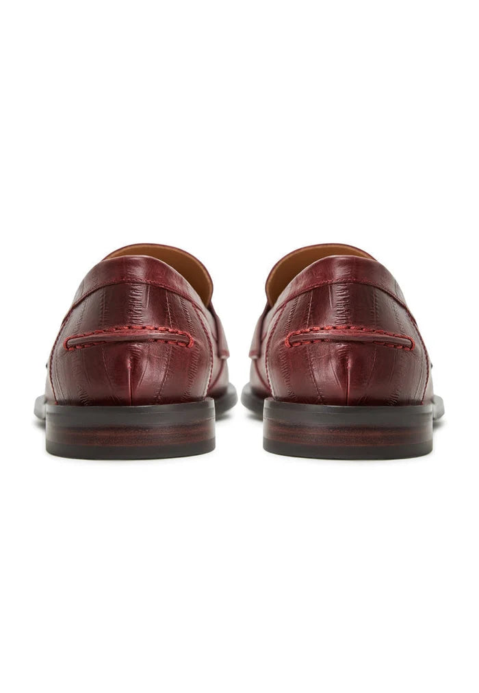 A stylish pair of women's leather loafers in burgundy, featuring a trendy block heel design for fashionable yet comfortable footwear.