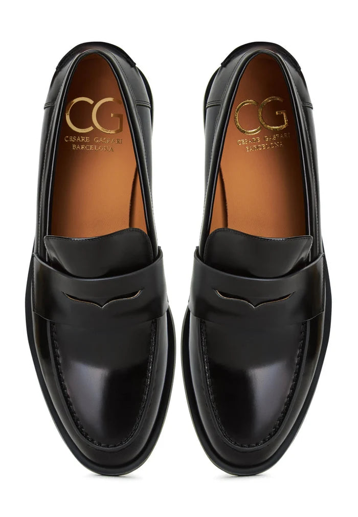 A stylish pair of patent black leather block heels, perfect for women who love a chic and versatile option like block heeled loafers.