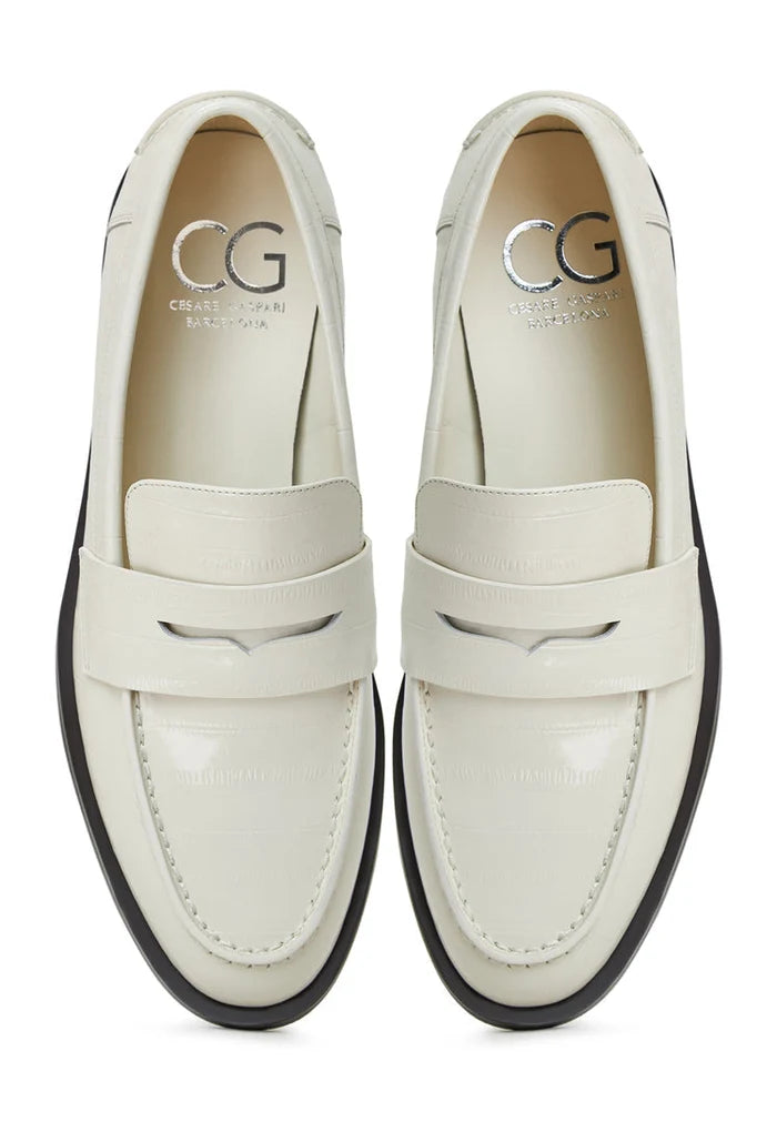 A stylish pair of white leather block heeled loafers, perfect for women looking for fashionable and comfortable leather slip-on shoes.