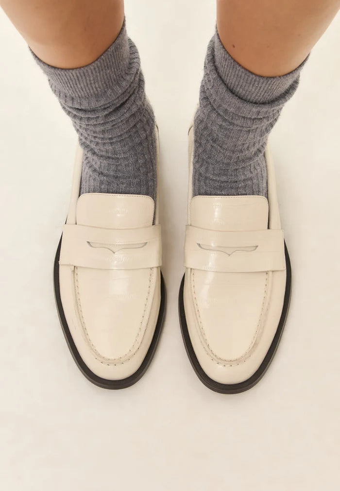 A stylish pair of white leather block heeled loafers for women, the perfect fashionable addition to any outfit.