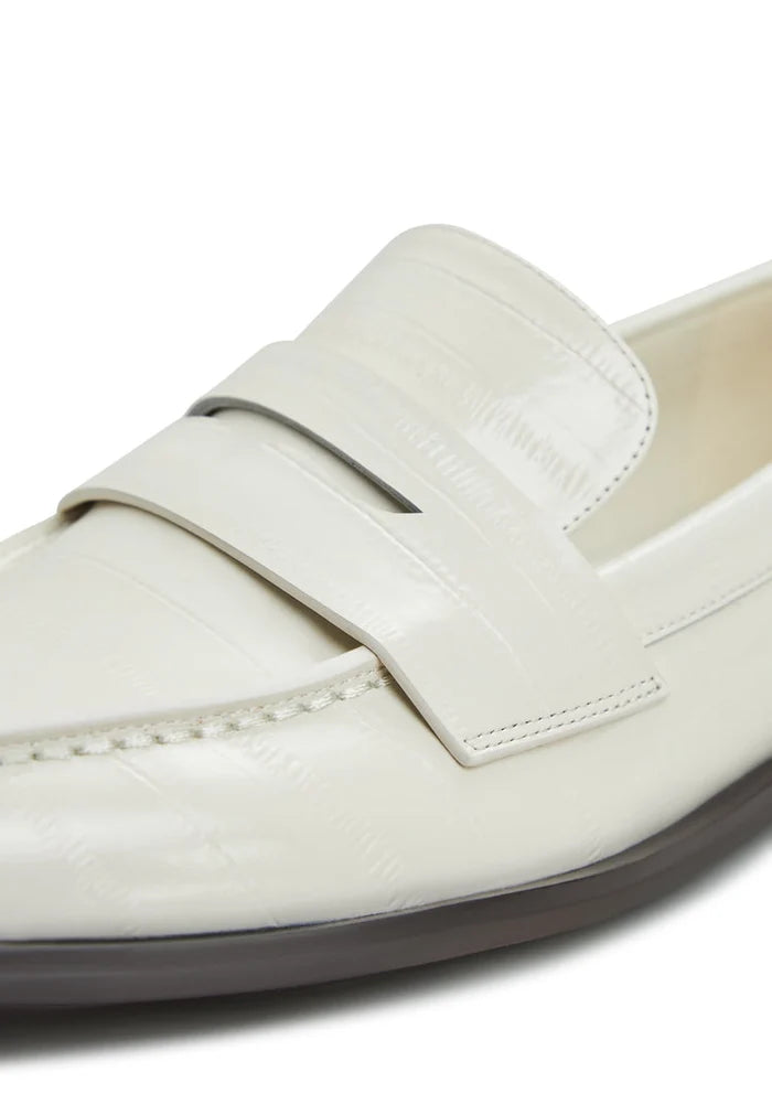 A stylish pair of women's leather block heeled loafers in white, perfect for trendy outfits and effortless style.