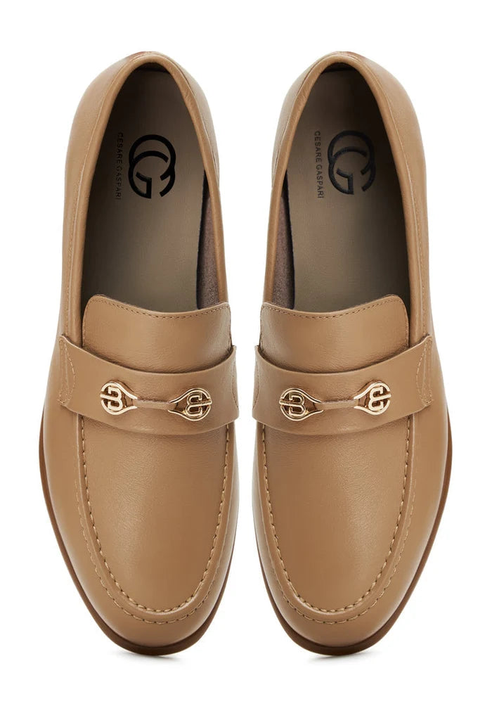 A stylish pair of women's beige leather block heeled loafers, known as the Abigail loafers, featuring a trendy block heel design.