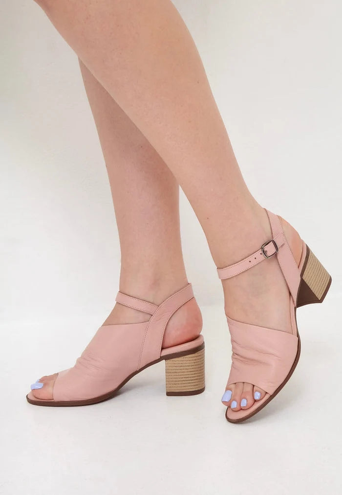 A stylish pair of women's pink leather block heel sandals, featuring a chunky heel design for a trendy and comfortable look.