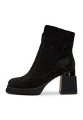 A stylish pair of women's black leather ankle boots with block heels, perfect for completing any fashion-forward look.
