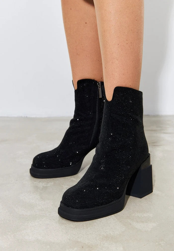 A stylish pair of black leather ankle boots with a block heel, perfect for women's fashion.