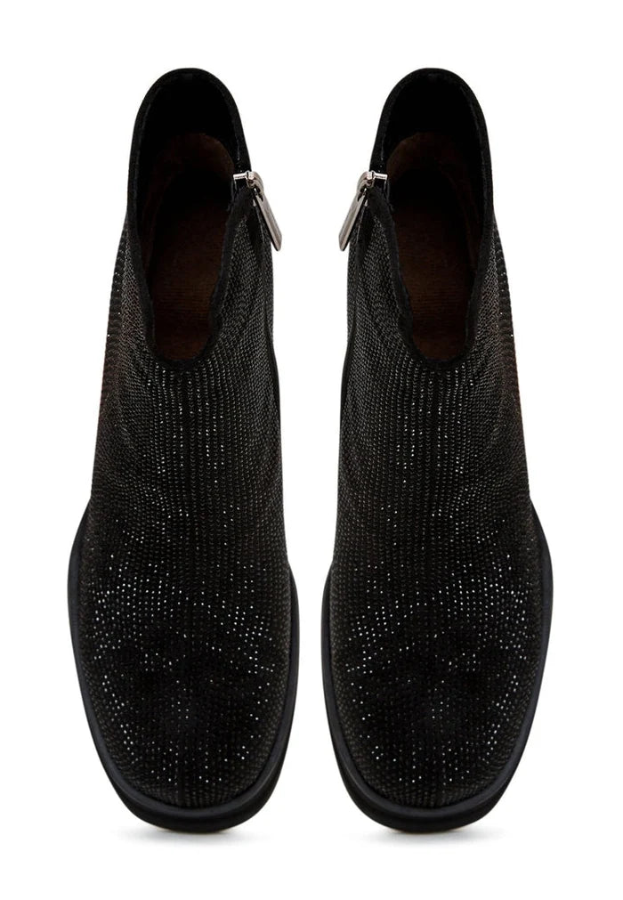 A fashionable pair of black leather ankle boots with a stylish block heel for women, ideal for completing any outfit with a touch of elegance and fashion-forward flair.