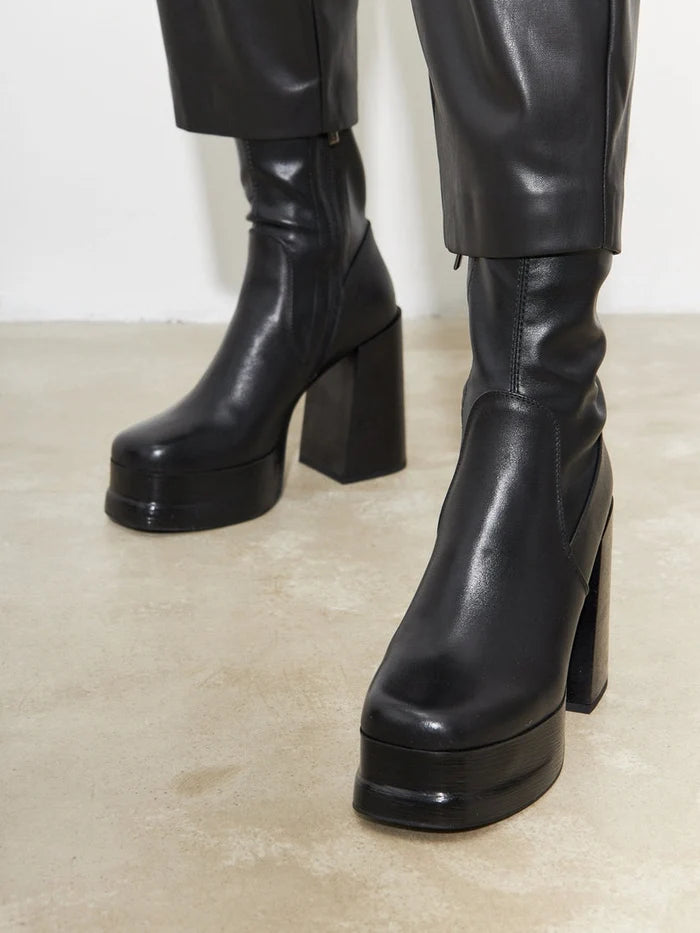 A fashionable pair of leather ankle boots for women, featuring high heels and stylish design.