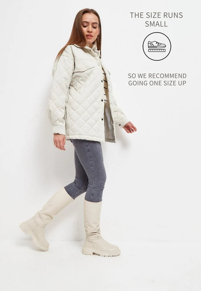 A stylish pair of women's knee-high leather boots in a trendy beige color, known as the Anastasia beige boots, perfect for any fashion-forward look.