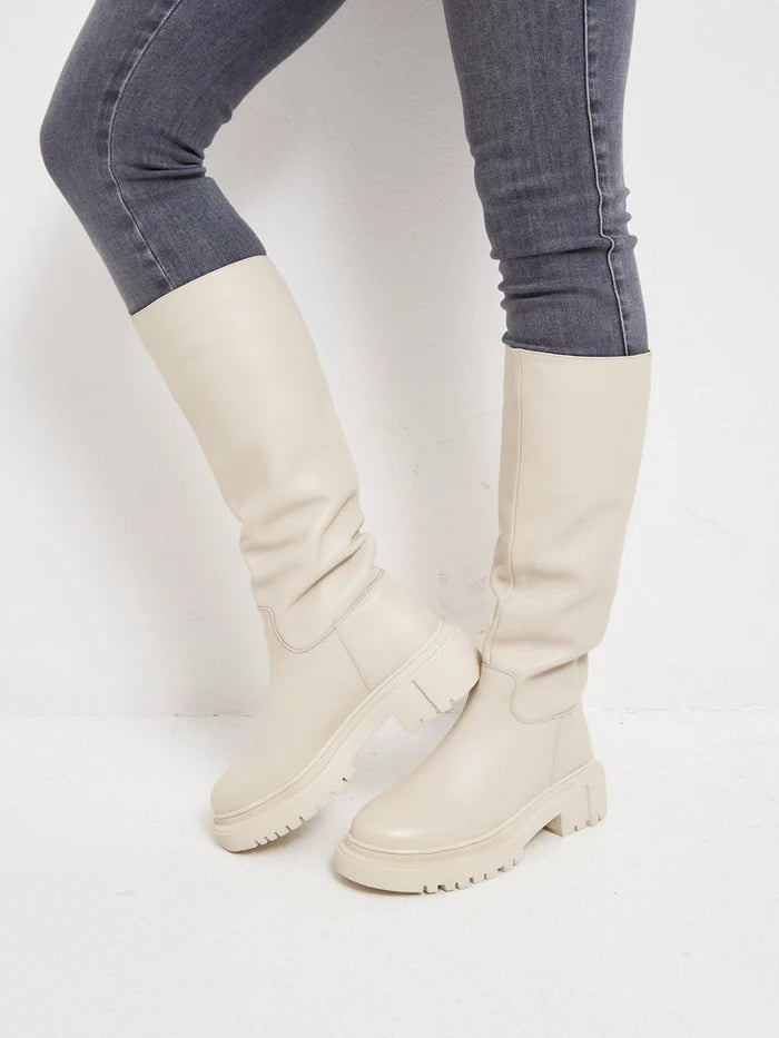 A trendy pair of women's knee-high leather boots in beige, known as Anastasia beige boots, perfect for stylish fashion enthusiasts.
