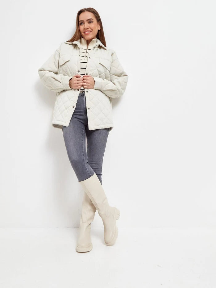A woman's legs wearing stylish knee-high Anastasia beige leather boots, the perfect choice for women's fashion.