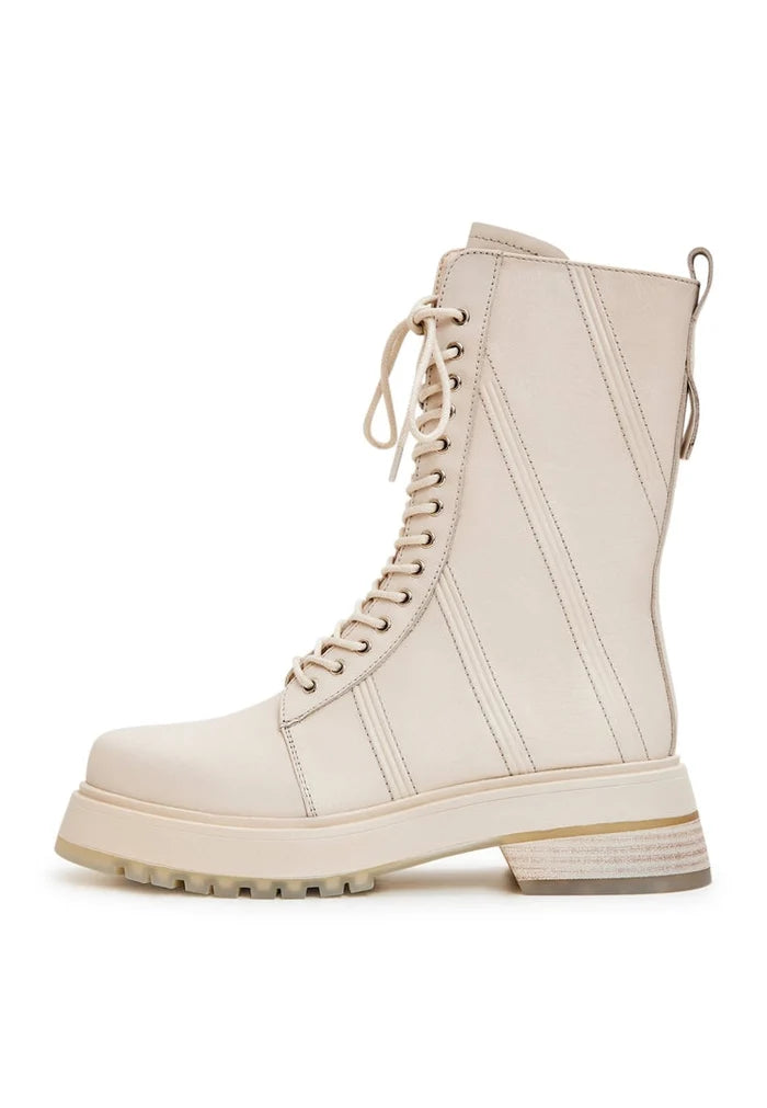 A stylish pair of women's lace-up leather ankle boots in beige, perfect for adding a touch of fashion to any outfit.