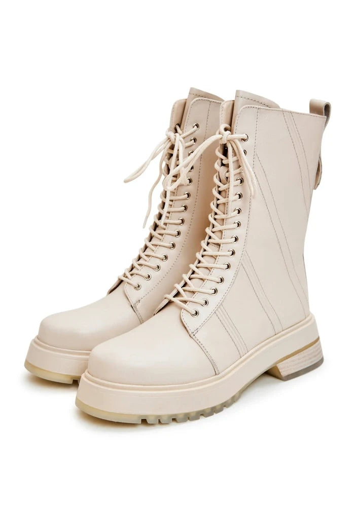 A stylish pair of women's beige leather lace-up ankle boots, perfect for fashion-forward looks.