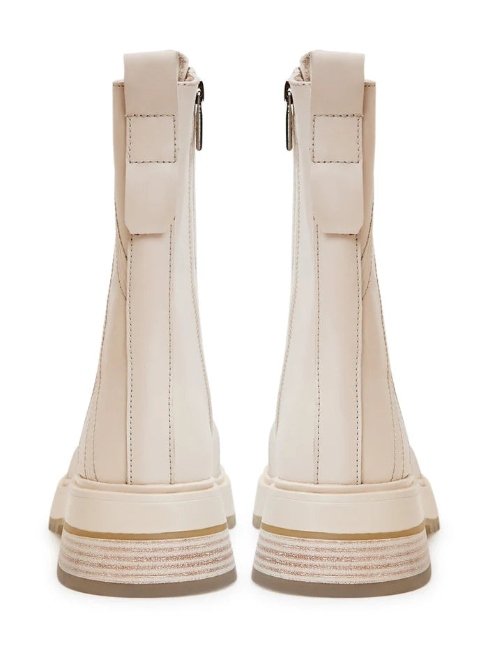 A pair of stylish women's beige leather lace-up ankle boots - perfect fashion statement for any outfit.