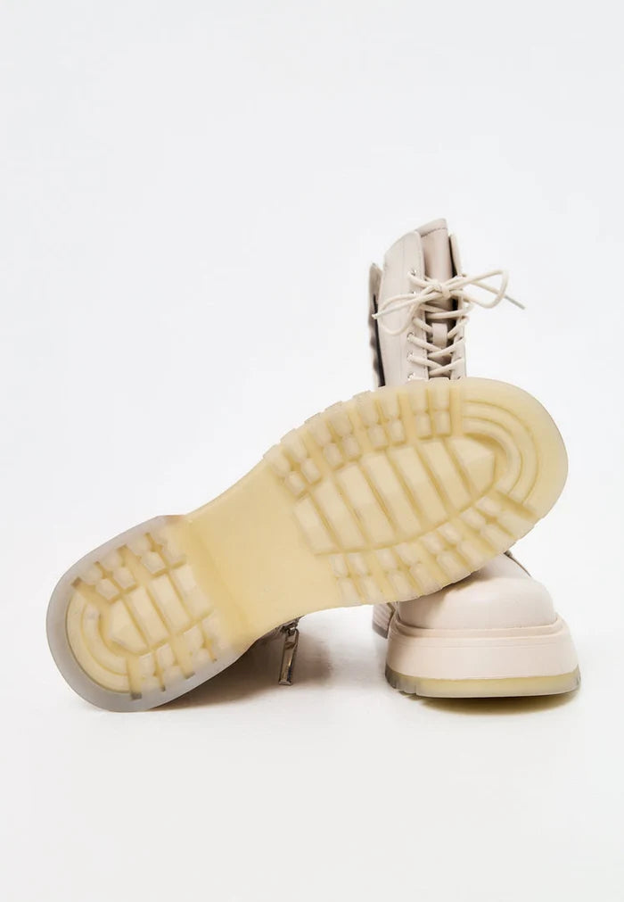A stylish pair of women's beige leather lace-up ankle boots, perfect for adding a fashionable touch to any outfit.
