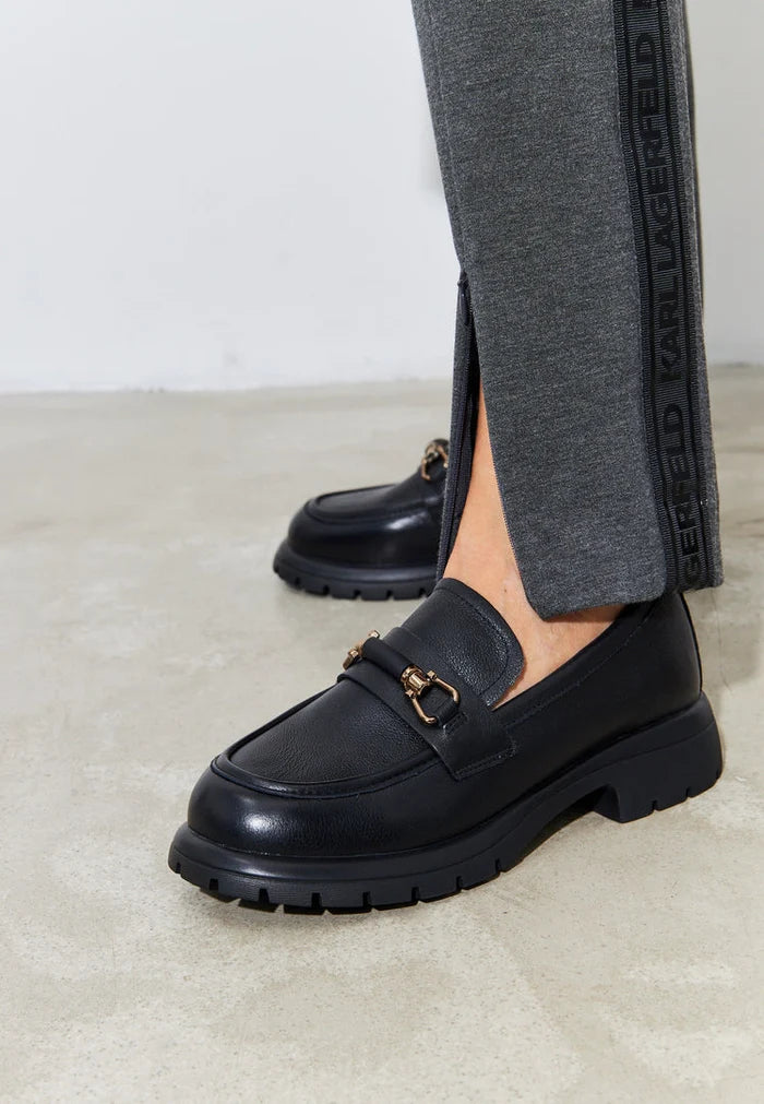 A stylish pair of black leather platform loafers, perfect for women who love comfortable and trendy slip-on shoes.