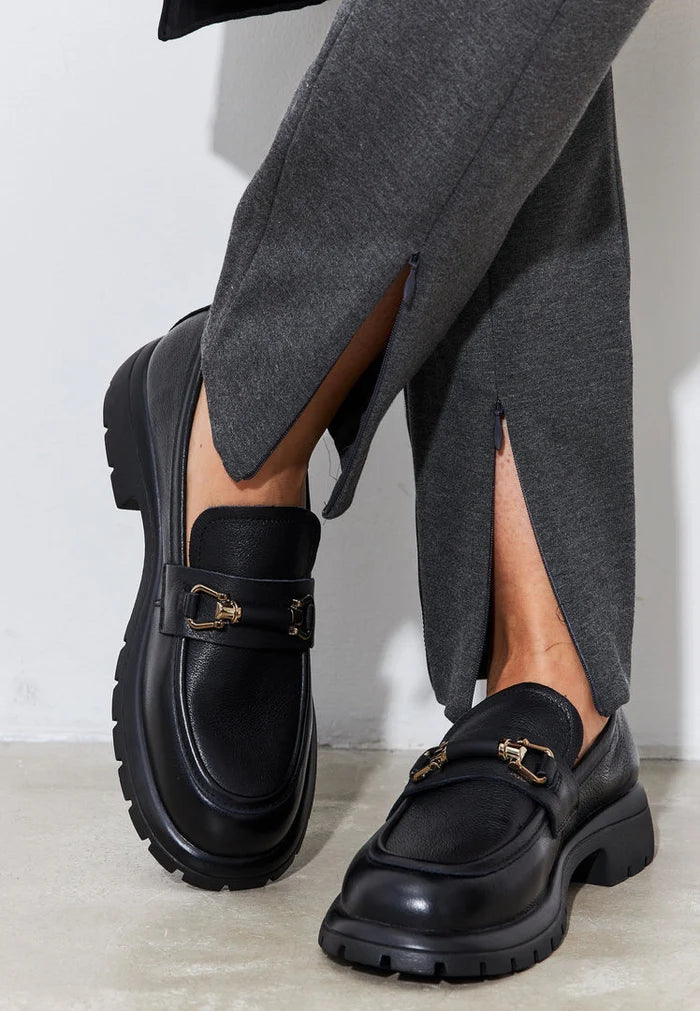 A stylish pair of women's black leather platform loafers, perfect for a chic and comfortable look.