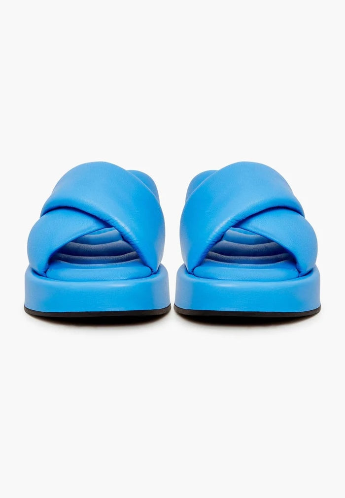 A stylish women's blue leather mule with a high platform heel, perfect for elevating any outfit.