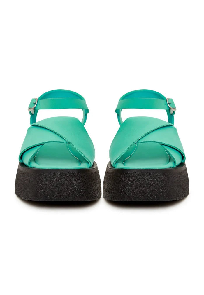 A stylish pair of high heel green leather platform sandals for women, perfect for chic summer outfits.