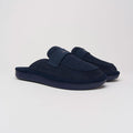 Three-quarter view of navy suede loafer showing cushioned backless silhouette and navy EVA sole on light gray background