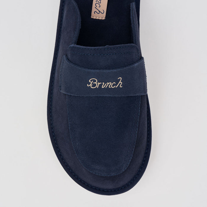 Top-down view of Loafer in navy suede showcasing embroidered Brunch strap and cushioned insole on light gray background