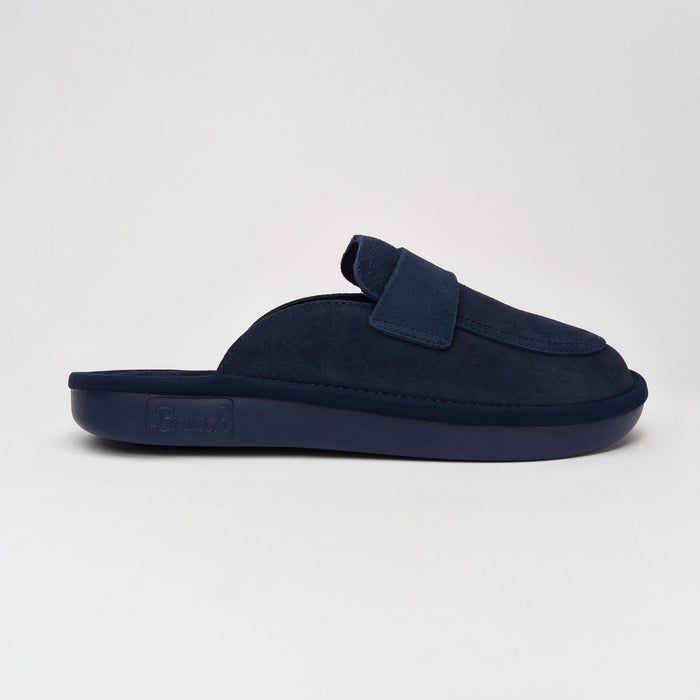 Side view of Loafer slipper in navy showcasing suede upper and cushioned partially recycled EVA outsole on light grey background