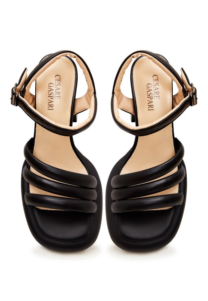 A stylish pair of women's black leather block heel sandals with an open toe design, perfect for a trendy and chic look.