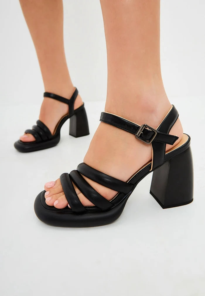 A chic pair of black open toe block heel sandals for women, crafted from stylish black leather, offering trendy and sophisticated style.