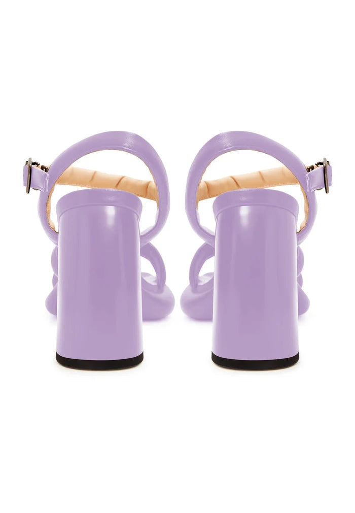 A pair of trendy lilac block heel sandals with an open toe design, perfect for any fashion-forward look.