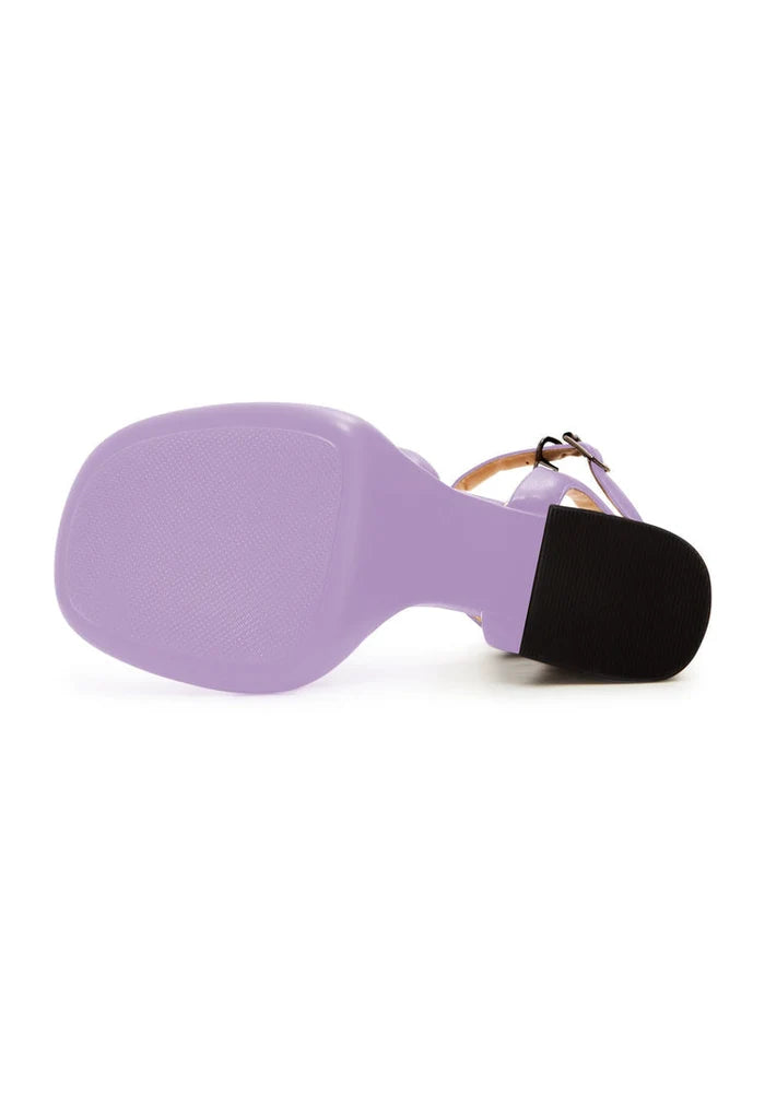A pair of trendy lilac block heel sandals with an open toe design, perfect for adding a stylish touch to any outfit.