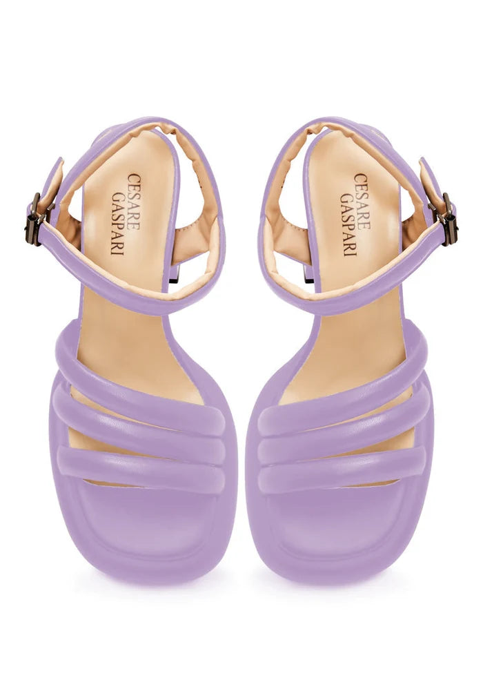 A trendy pair of lilac block heel sandals with an open toe design, perfect for a fashionable summer look.
