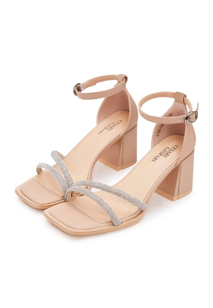 A close-up of stylish beige open toe leather block heeled sandals, perfect for a chic and comfortable summer look.
