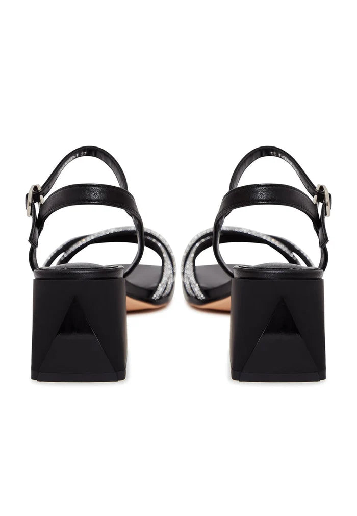 A pair of black leather block heel open toe sandals with high heels, known as the Andrea sandals.
