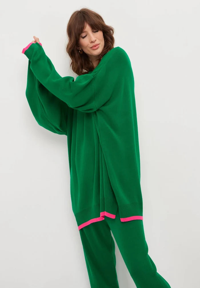 A cozy and stylish oversized green jogger set featuring an oversized sweatshirt and joggers, perfect for lounging or running errands in this plus size jogging suit.