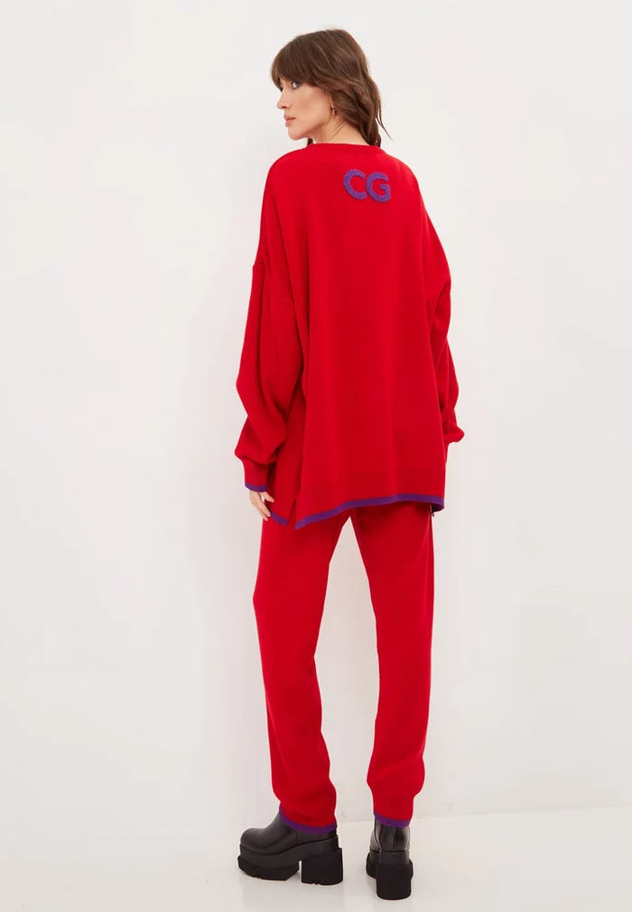 A woman wearing an oversized red lounge set with comfy sweatpants, a perfect plus size activewear look for a stylish and relaxed athleisure outfit.