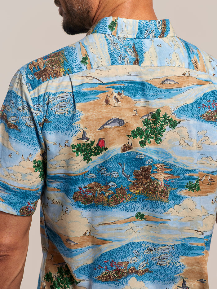Ocean Blue, green, and beige island-print cotton short-sleeve Hawaiian shirt, back view.