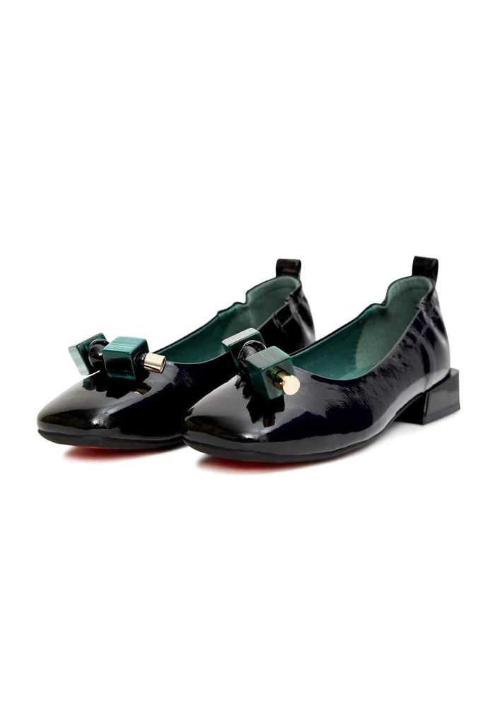 A pair of elegant black patent leather ballet flats with embellished details, perfect for stylish women.