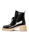 A stylish pair of black patent leather lace-up ankle boots for women, ideal for adding a touch of sophistication to any outfit.