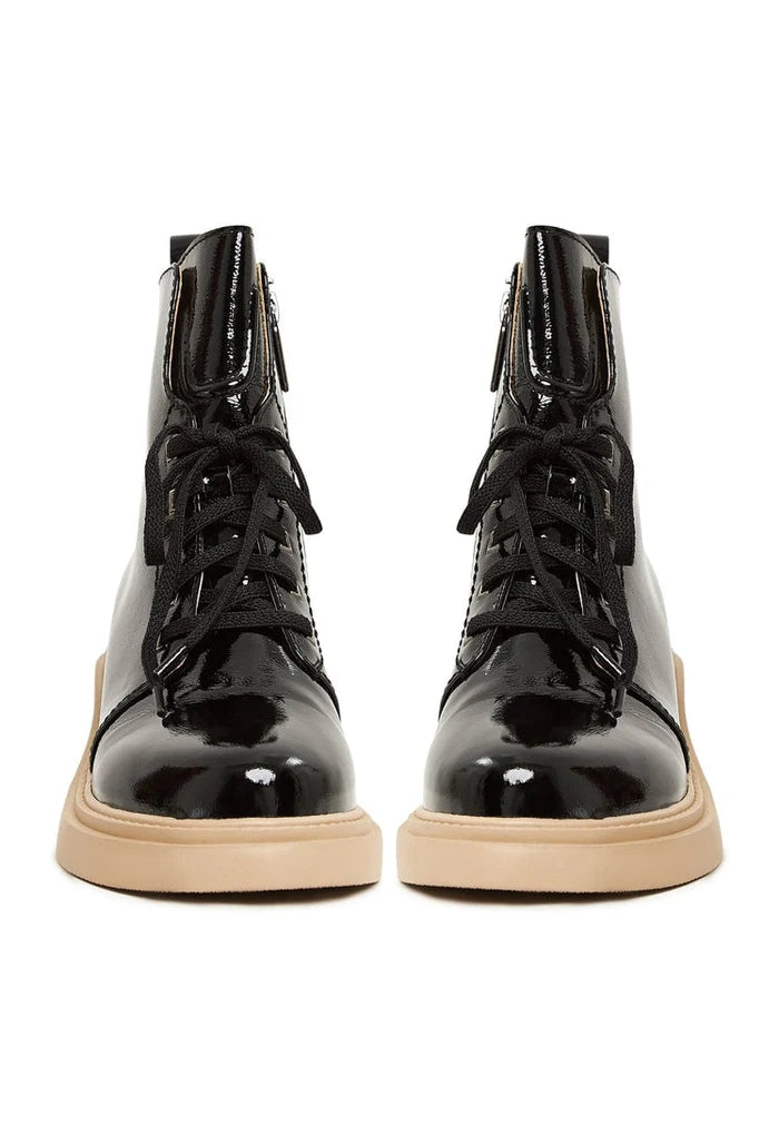 A stylish pair of patent leather lace-up ankle boots in black, perfect for women seeking fashionable patent leather footwear.