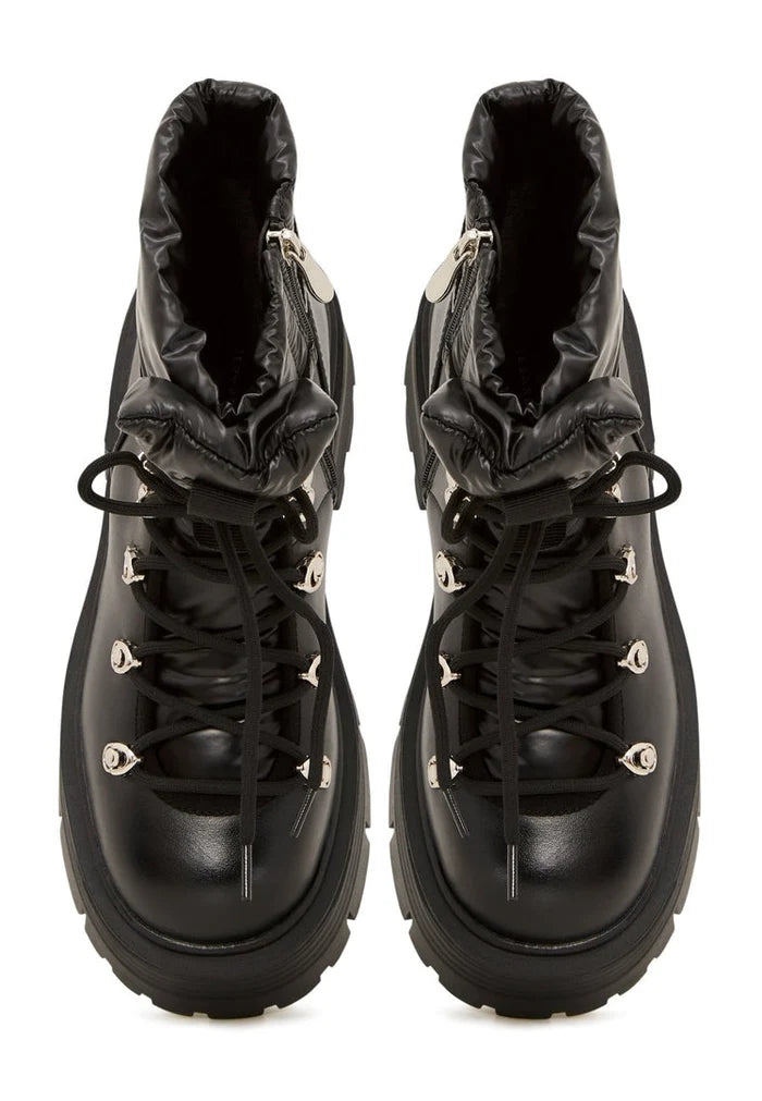 A trendy pair of peep-toe ankle boots, also known as open-toe booties, perfect for the summer season. These cut-out ankle boots are a must-have in women's shoe trends.