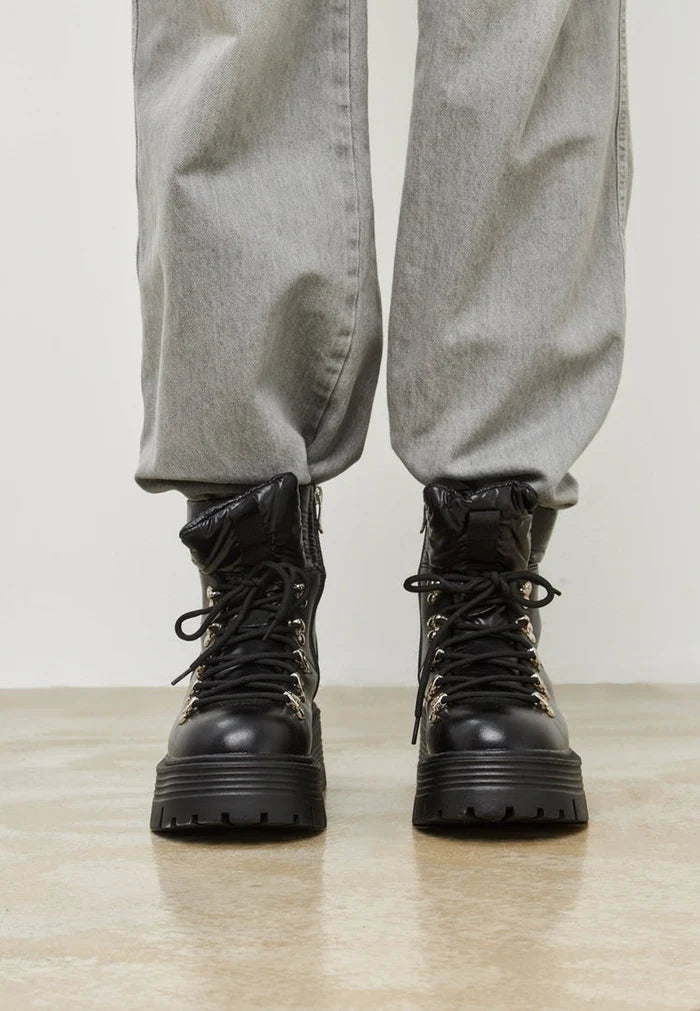 A stylish pair of peep-toe ankle boots, perfect for the summer and on-trend with cut-out details in women's shoe fashion.