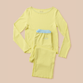 Flat lay of Sunshine Yellow pajama set with picot-trim neckline, blue waistband, and Brunch embroidery on pink background