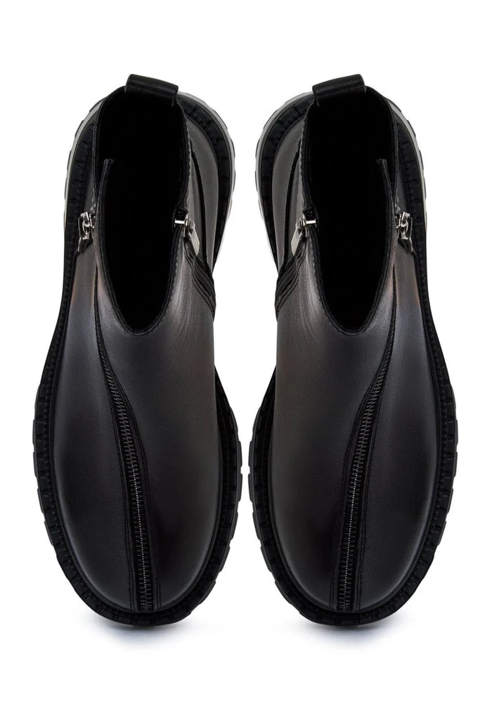 A chic pair of black leather platform ankle boots for women with high heels.