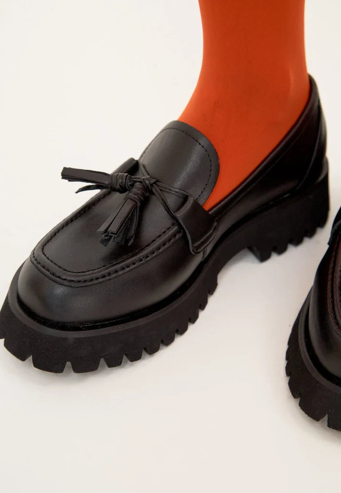 A stylish pair of black platform loafers with a chunky sole, the Ksenia platform loafers, perfect for women looking for trendy and comfortable black casual footwear.