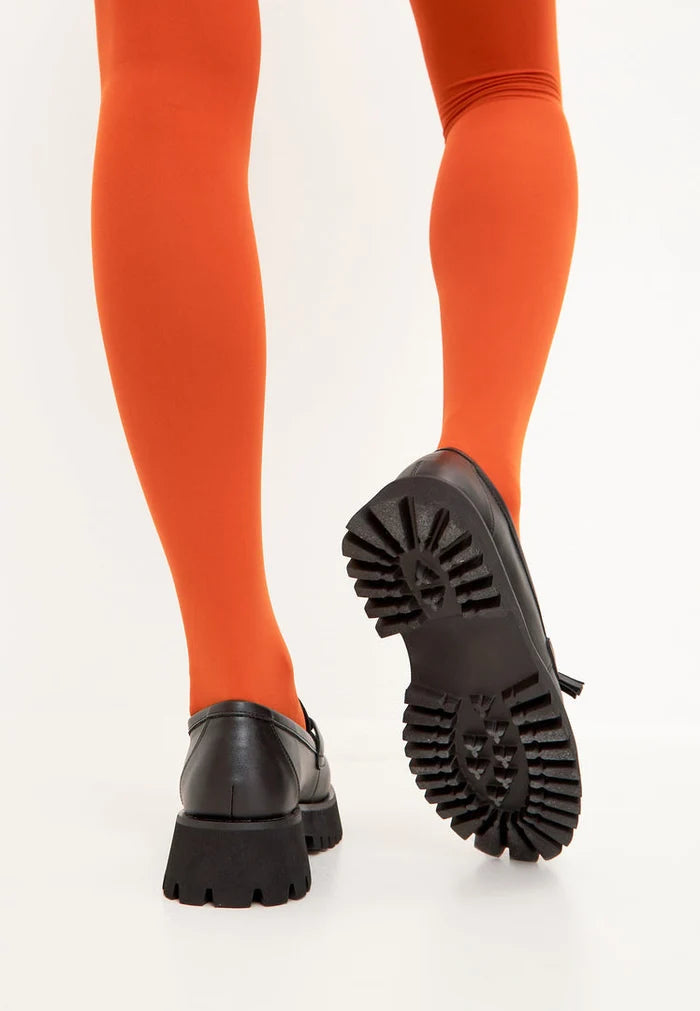 A stylish pair of black platform loafers with a chunky sole, perfect for adding a touch of edgy sophistication to any outfit.