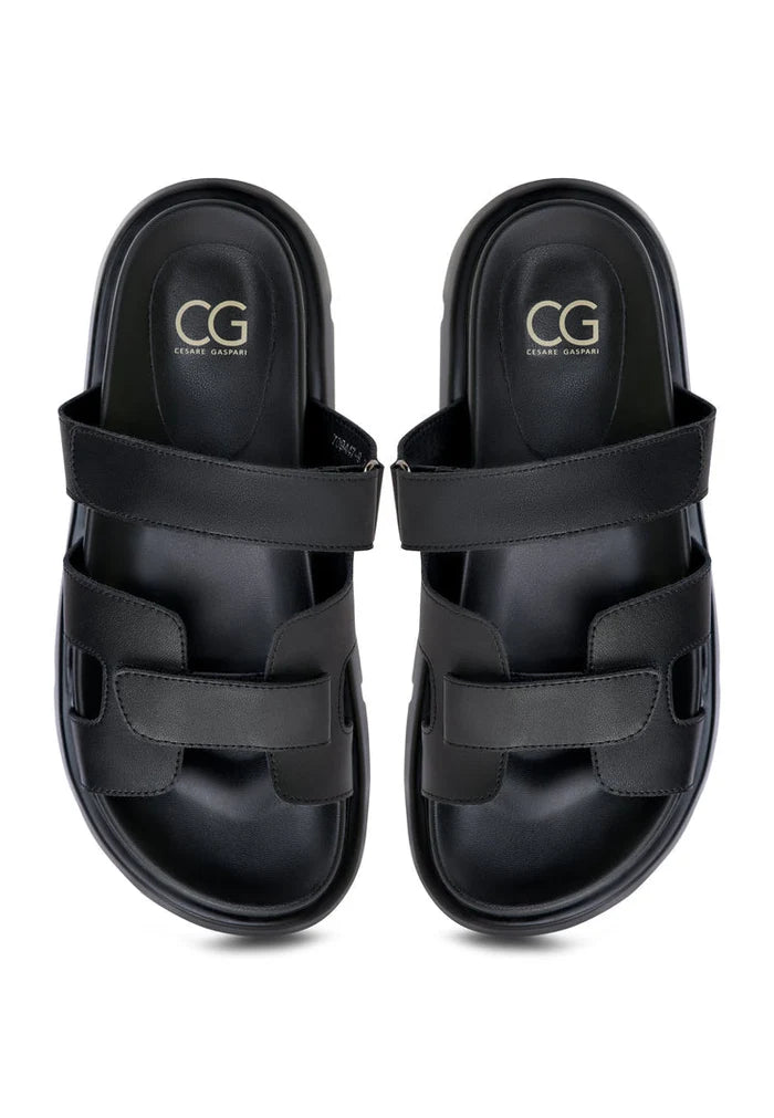 A stylish pair of black Kati platform mules on a white background.